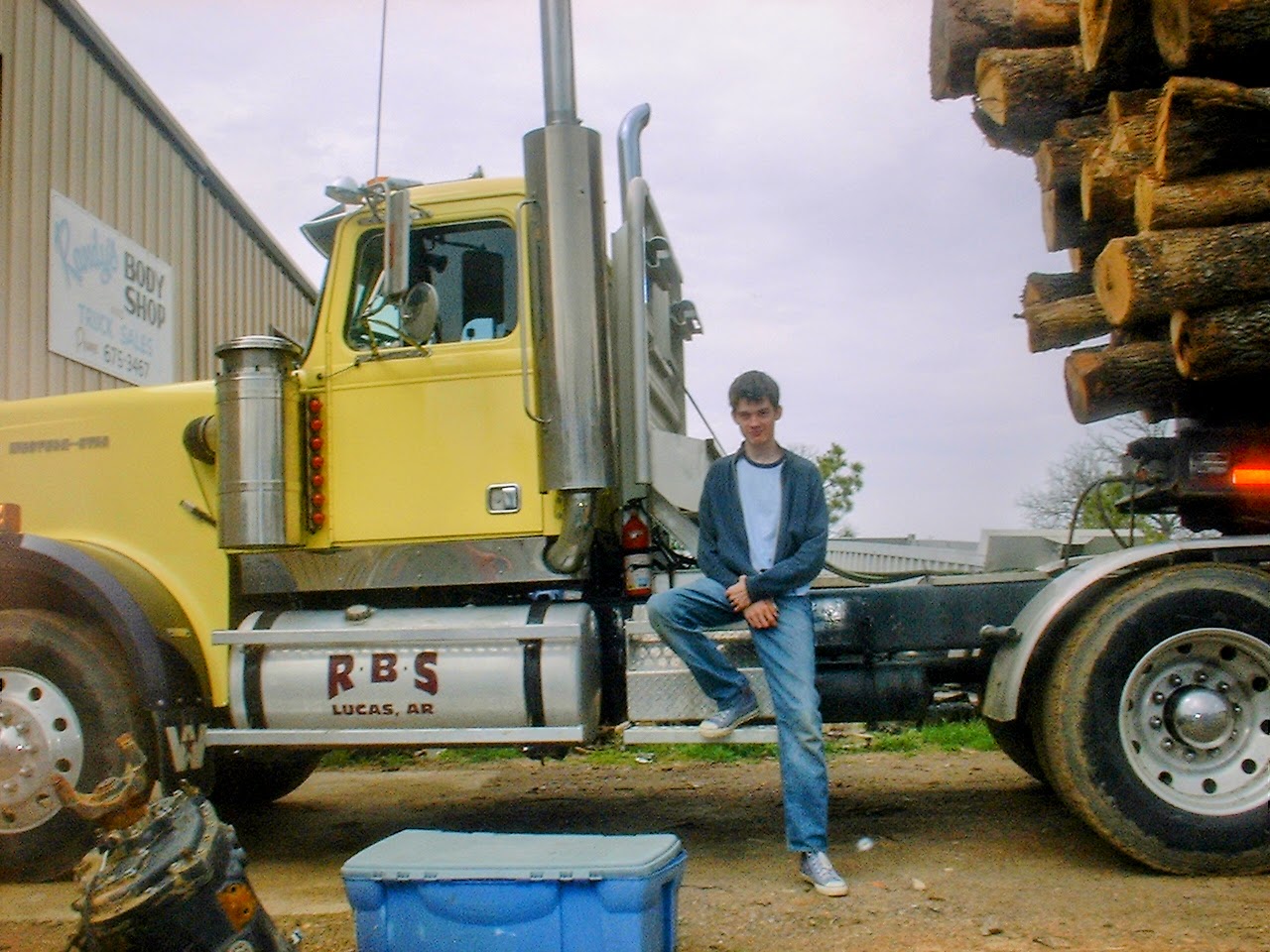 Jesse Hattabaugh sitting on his father's log truck in March of 2002.