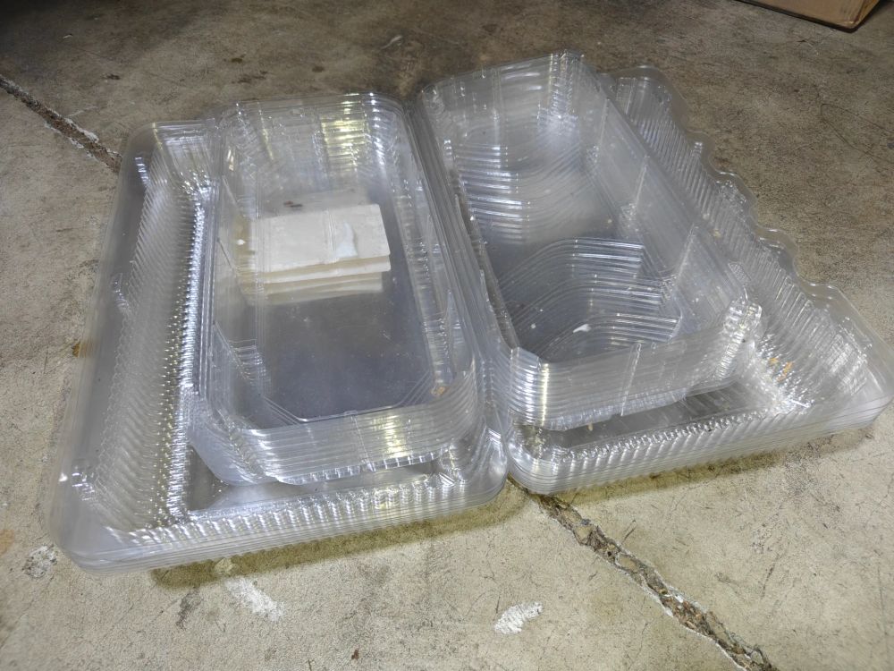 Two stacks of plastic Costco pastry boxes